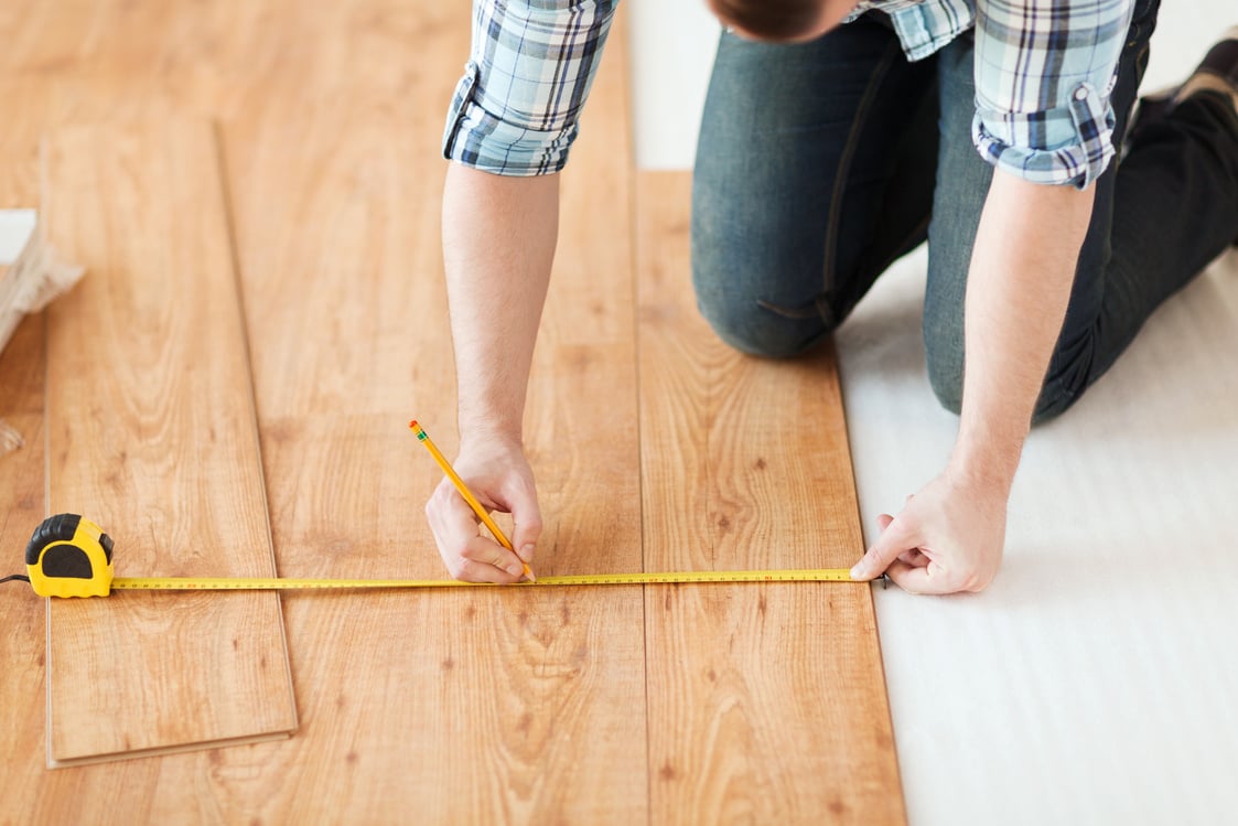 Male Measuring Wood Flooring